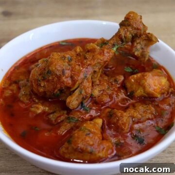 chicken curry served in a white bowl.