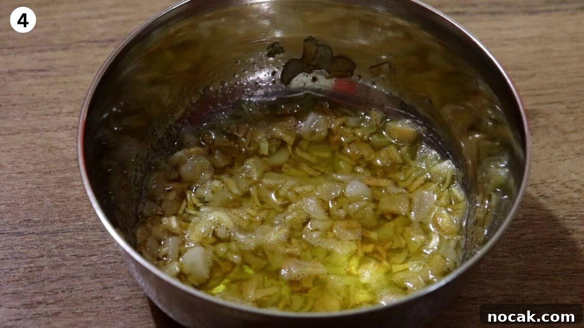 Garlic Chicken Curry (Lehsuni Murgh) Recipe — Aromatic Indian Dish 6 fried garlic removed in a bowl to make garlic chicken.