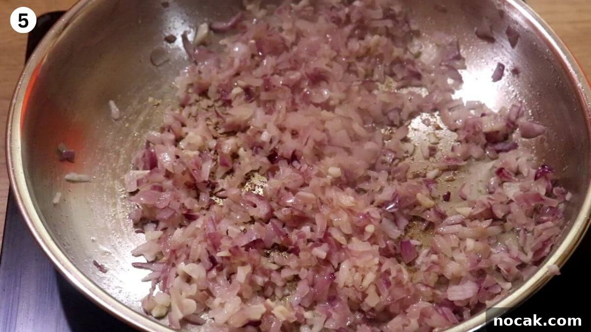 Garlic Chicken Curry (Lehsuni Murgh) Recipe — Aromatic Indian Dish 7 sauteing onions to make garlic chicken curry.