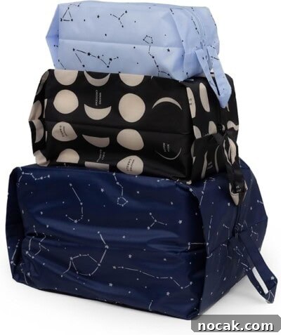 2025 Holiday Gift Guide: Top Picks for Every Recipient 7 Three rectangular zippered pouches stacked on top of each other; the top one is light blue with constellation patterns, the middle is black with moon phases, and the bottom is dark blue with constellation patterns.