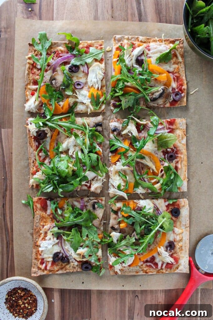High-Protein Lavash Pizza Ready in 10 Minutes 2 Lavash bread pizza topped with arugula and cut into slices.