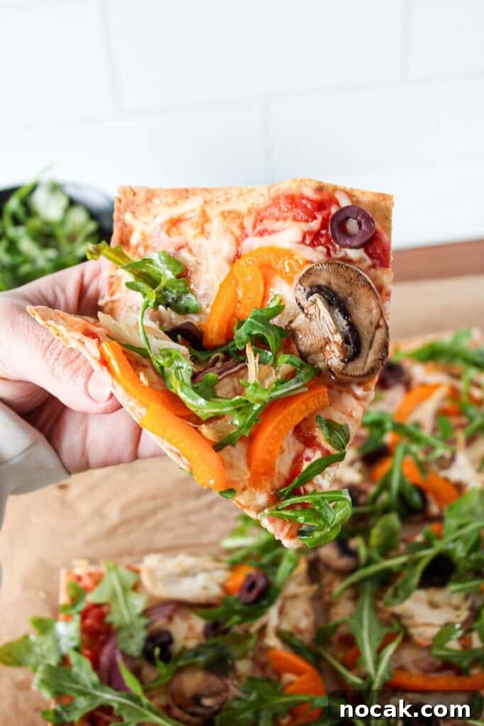 High-Protein Lavash Pizza Ready in 10 Minutes 11 A close up of a slice of lavash bread pizza.