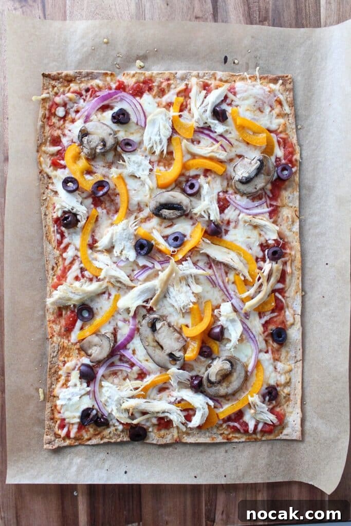 High-Protein Lavash Pizza Ready in 10 Minutes 7 A lavash bread pizza baked and on a piece of parchment paper