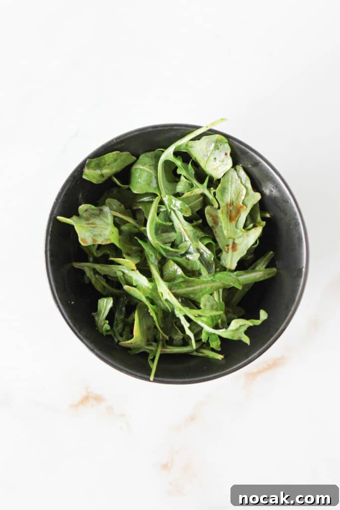 High-Protein Lavash Pizza Ready in 10 Minutes 9 Baby arugula dressed with balsamic vinegar, olive oil, salt and pepper.