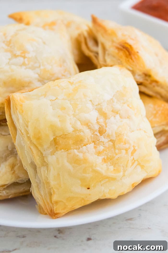 One-Pan Chicken Puff Pastry Bake 4 Chicken Parcels on White Plate