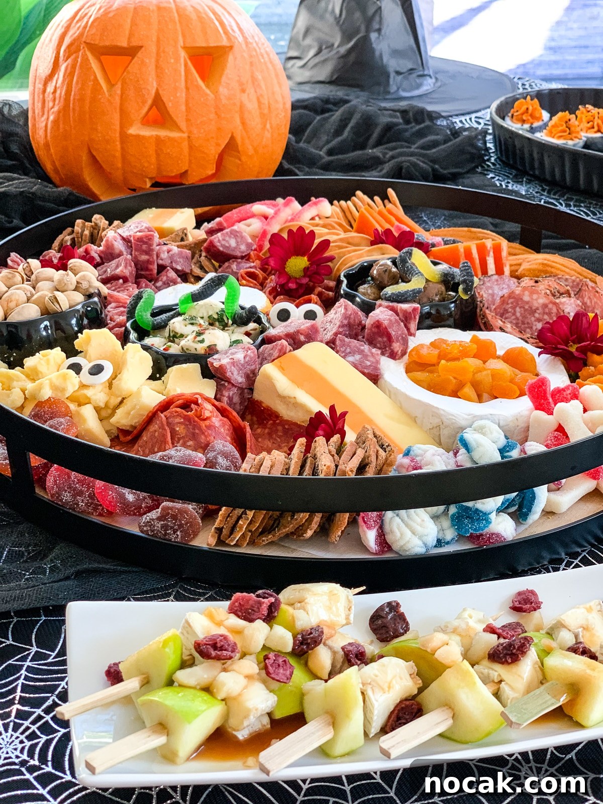 Spooky Halloween Charcuterie Board Ideas for Your Party 3 A Halloween charcuterie board loaded with cheese and meat, with some other appetizers.