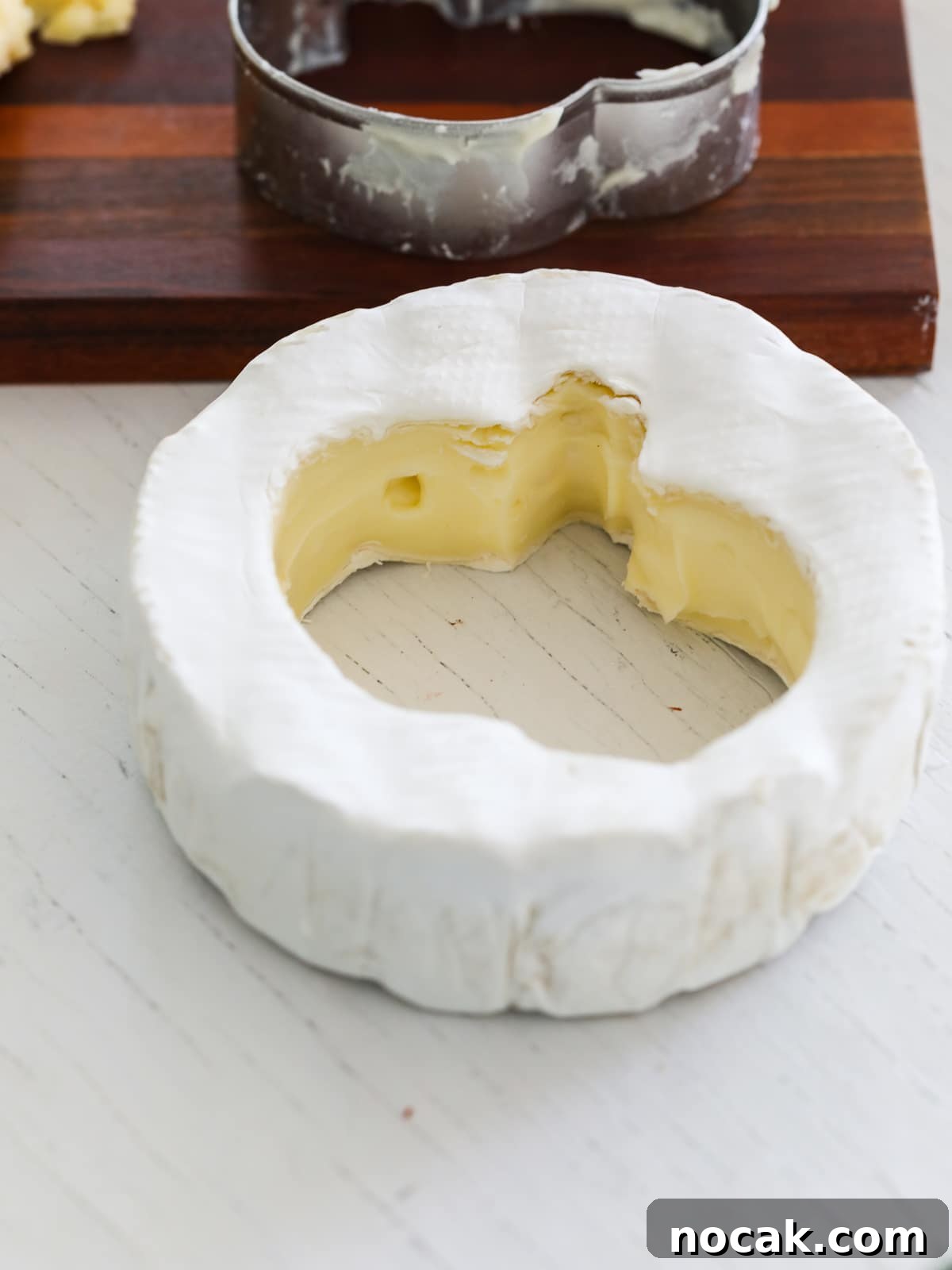 Spooky Halloween Charcuterie Board Ideas for Your Party 10 A pumpkin shape cut out of a wheel of brie for a charcuterie board.