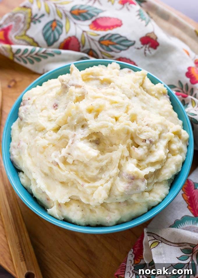 Thanksgiving Recipes for Instant Pot: Fast Holiday Favorites 12 Creamy Mashed Potatoes in a blue bowl and a floral napkin all on a wooden board