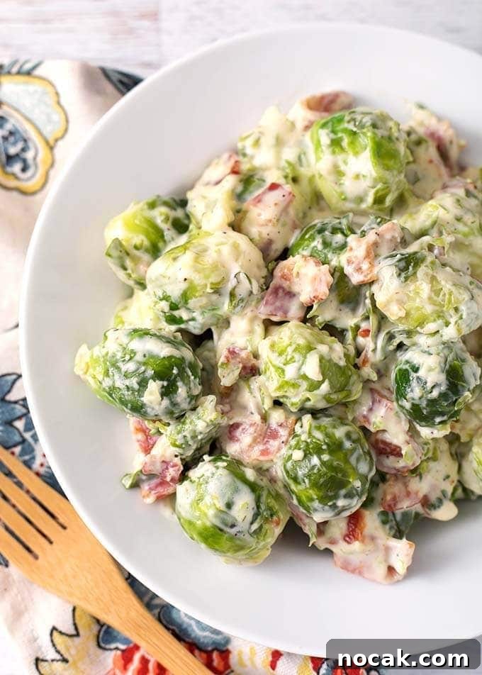 Thanksgiving Recipes for Instant Pot: Fast Holiday Favorites 14 Creamy Bacon Brussels Sprouts on a white plate next to a wooden fork