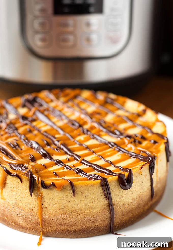 Thanksgiving Recipes for Instant Pot: Fast Holiday Favorites 19 Pumpkin Cheesecake on a white plate in front of a pressure cooker