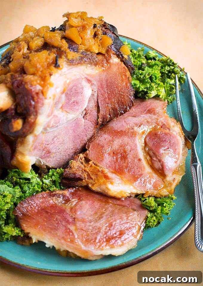 Thanksgiving Recipes for Instant Pot: Fast Holiday Favorites 4 Bone-in Ham with green leafy vegetable on a turquoise plate with a silver fork