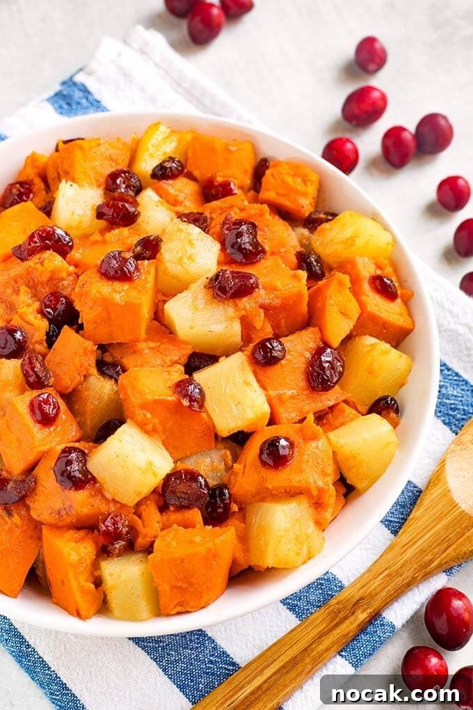 Thanksgiving Recipes for Instant Pot: Fast Holiday Favorites 8 Sweet Potato Cranberry Casserole in a white bowl on a white and blue striped napkin