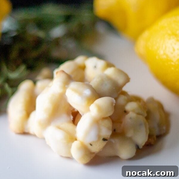 Lemon Rosemary Shortbread Cookies: Citrusy Herb Tea Treat 3 Lemon rosemary cookies lie in a pile on a table.