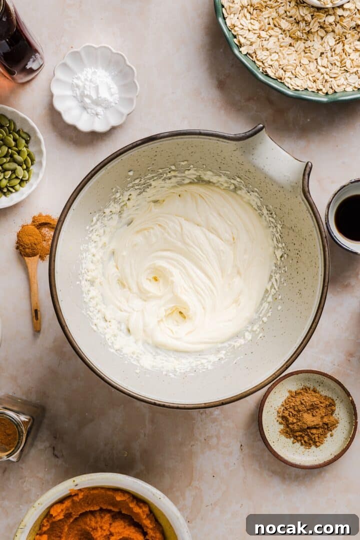 Pumpkin Cream Cheese Muffins with Swirled Filling and Spice 4 Cream cheese whisked in a large bowl.