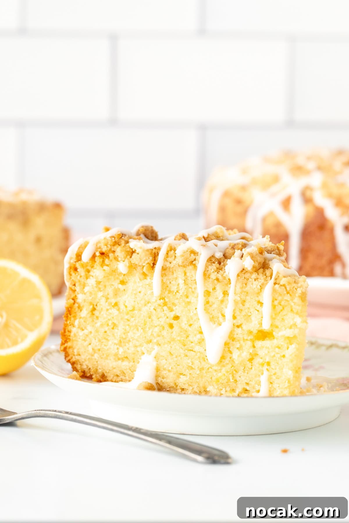 Lemon Coffee Cake Recipe: Moist Citrus Bundt Cake for Brunch 2 Slice of lemon coffee cake with crumb topping and drizzle of glaze
