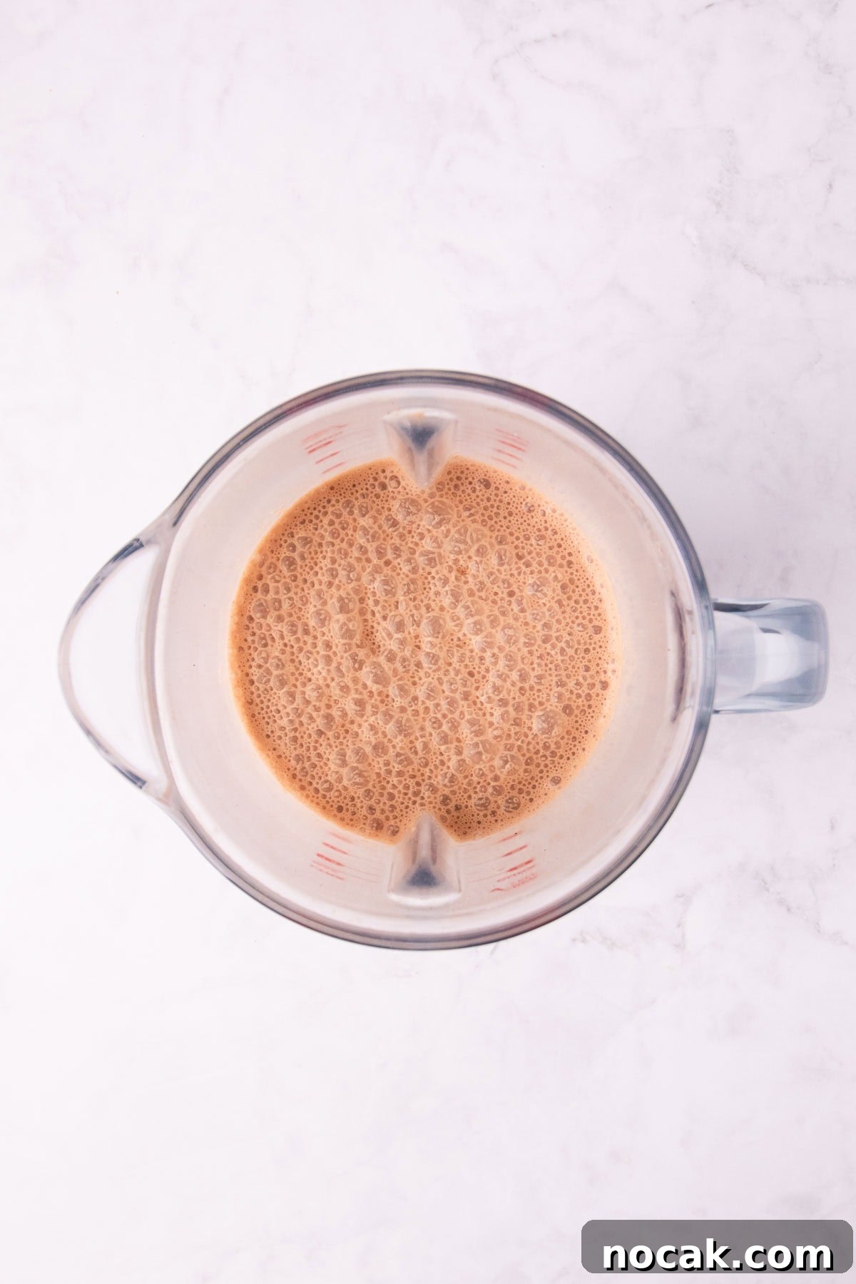 Creamy Mocha Milkshake Recipe: How to Make the Perfect Coffee Chocolate Shake 6 Overhead view of the blended shake in a clear blender jug.