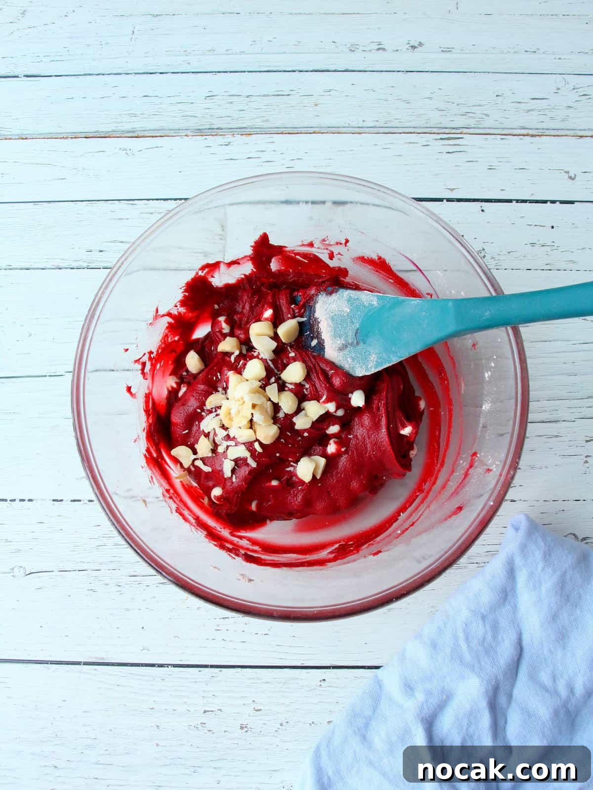 Red Velvet Heart Cookies: Soft Valentine’s Day Treats 9 red velvet cookie batter mixing in macadamia nuts