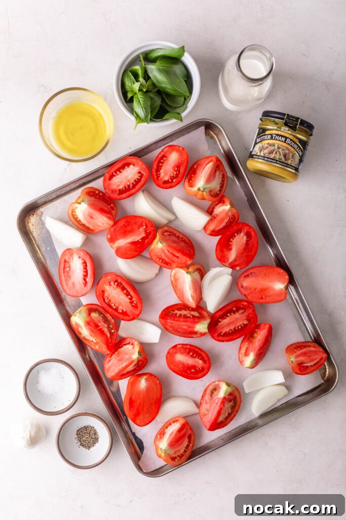 Creamy Sheet-Pan Roasted Tomato Soup 4 creamy roasted tomato soup ingredients. pan with sliced tomatoes and onions, cooking oil, fresh basil, heavy cream, chicken bouillon, salt, pepper, and garlic cloves