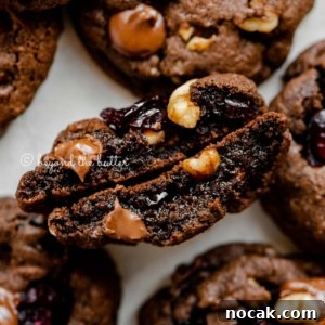 Dark Chocolate Cranberry Walnut Cookie Recipe for Rich, Chewy Treats 7 Dark chocolate cranberry walnut cookie split in half to see the inside.