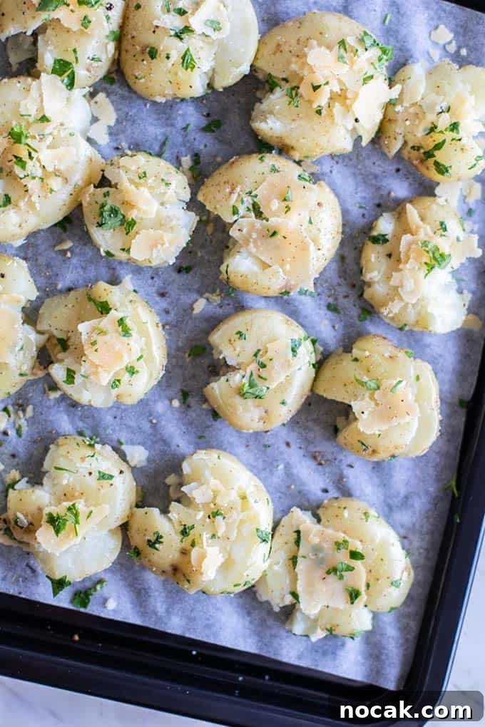 Crispy Parmesan Oven-Baked Smashed Potatoes 4 A close up look at how to smash potatoes on a baking tray.