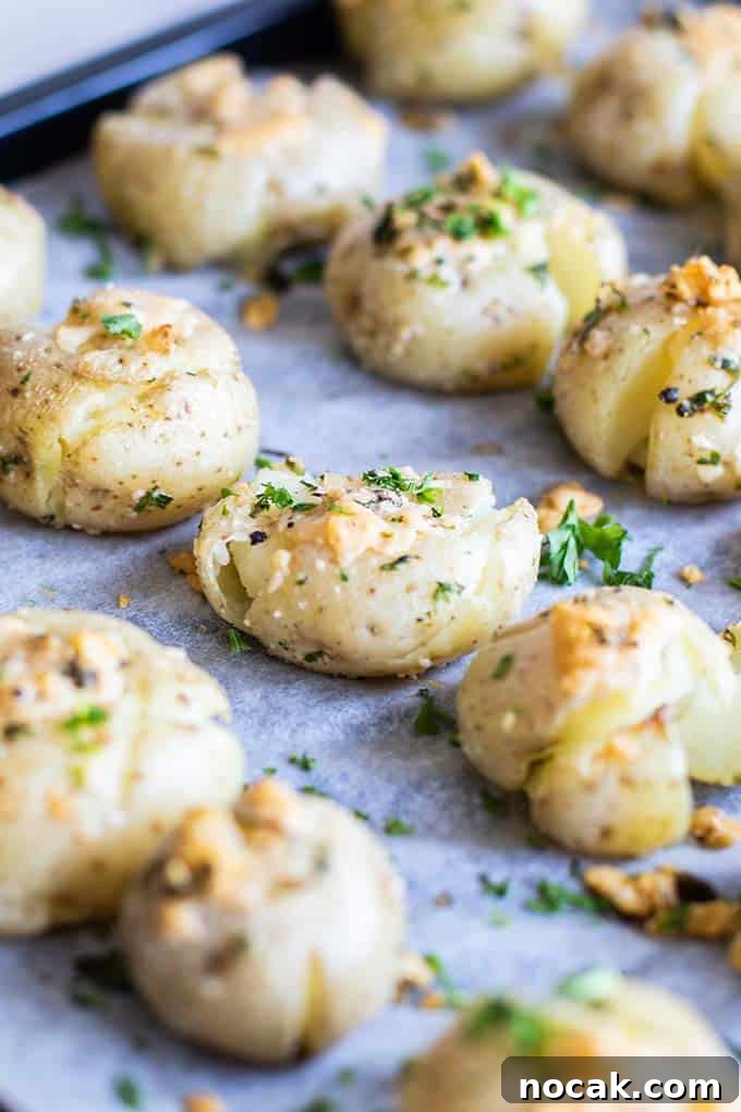 Crispy Parmesan Oven-Baked Smashed Potatoes 5 A side angle view of smashed potatoes on a baking tray.