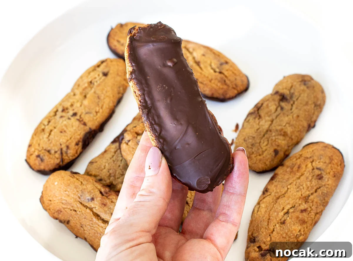 holding dunker cookie dipped in chocolate