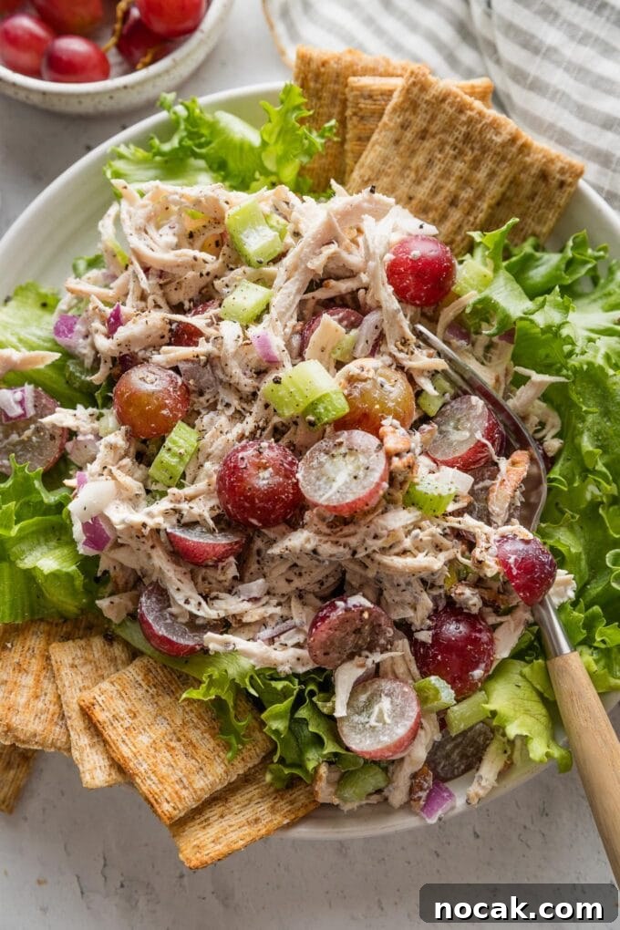 Sun-Drenched Sonoma Chicken Salad with Grapes & Almonds 2 Whole Foods copycat Sonoma chicken salad plated over green leaf lettuce with Triscuits on the side.