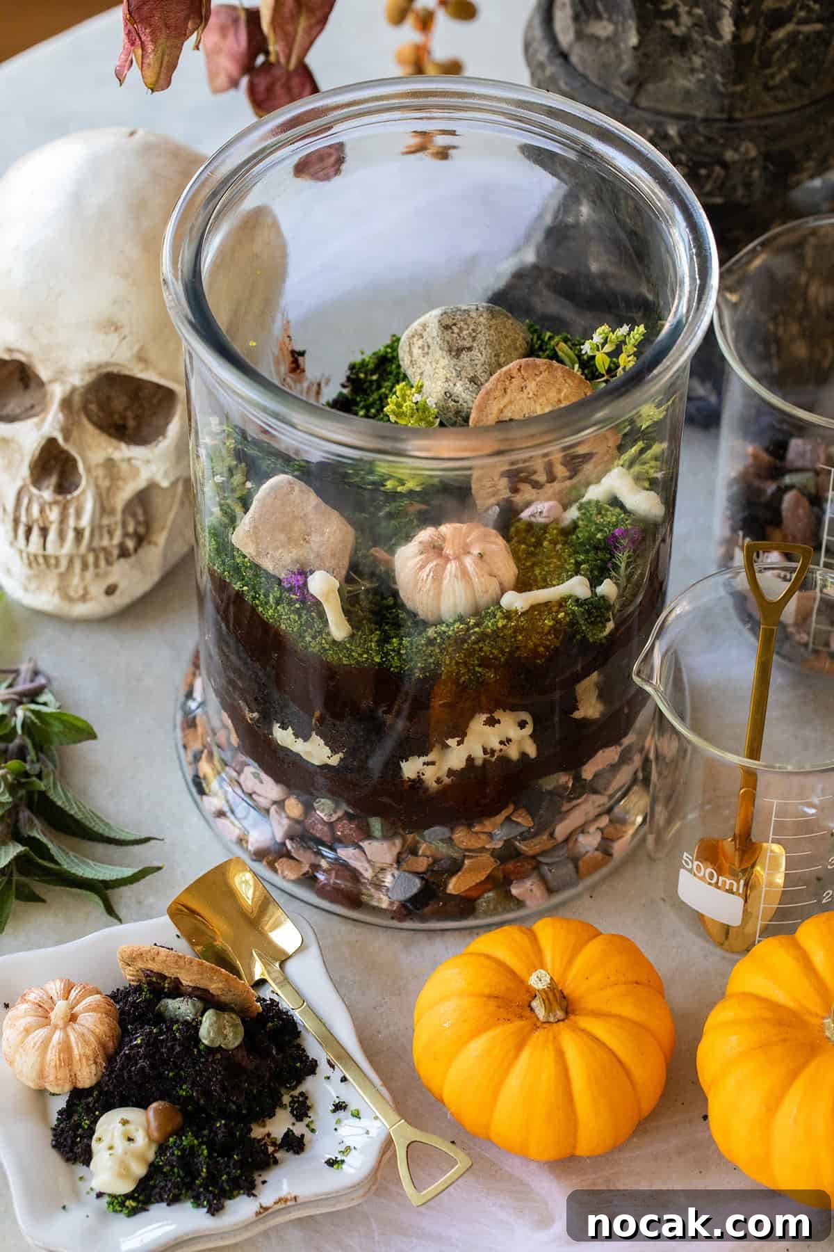 DIY Edible Halloween Terrarium: Spooky Candy Garden Tutorial 2 Edible Halloween Terrarium with chocolate cake, frosting, edible rocks and bones.