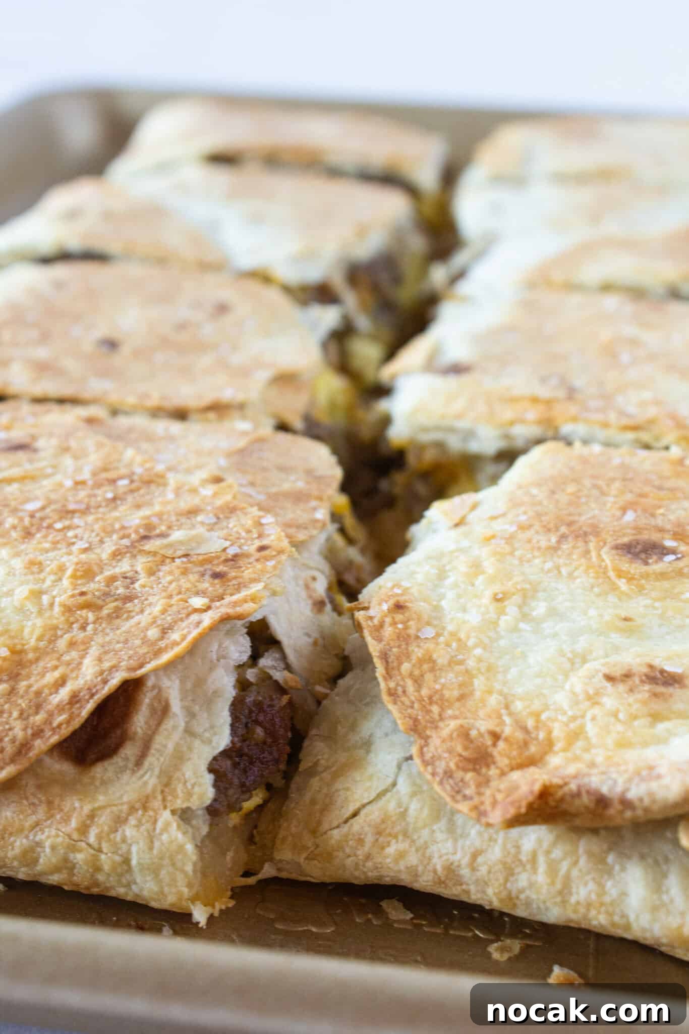A Sheet Pan Breakfast Quesadilla on a tray and cut into 8 squares.
