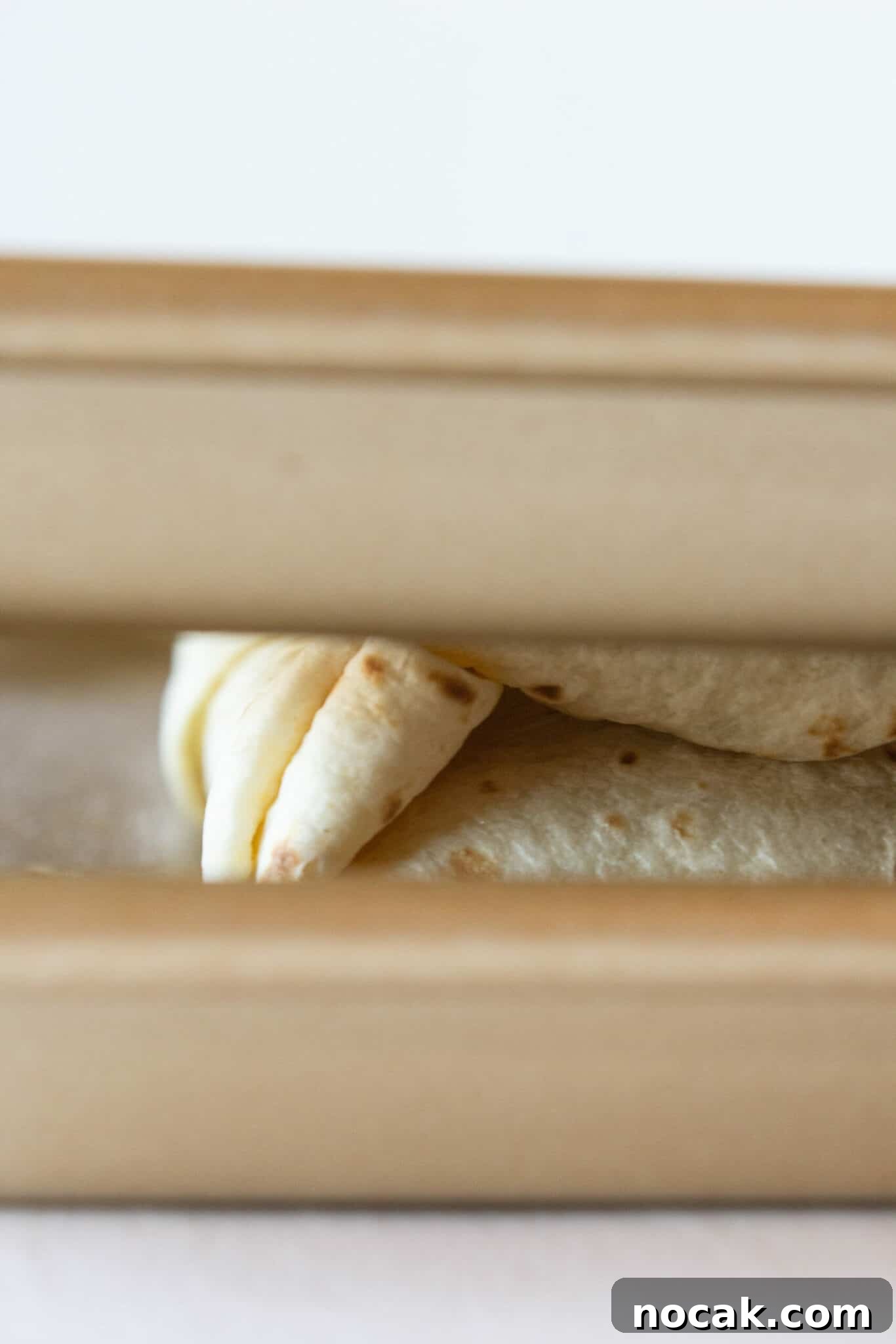 Folding the Sheet Pan Breakfast Quesadillas for baking.