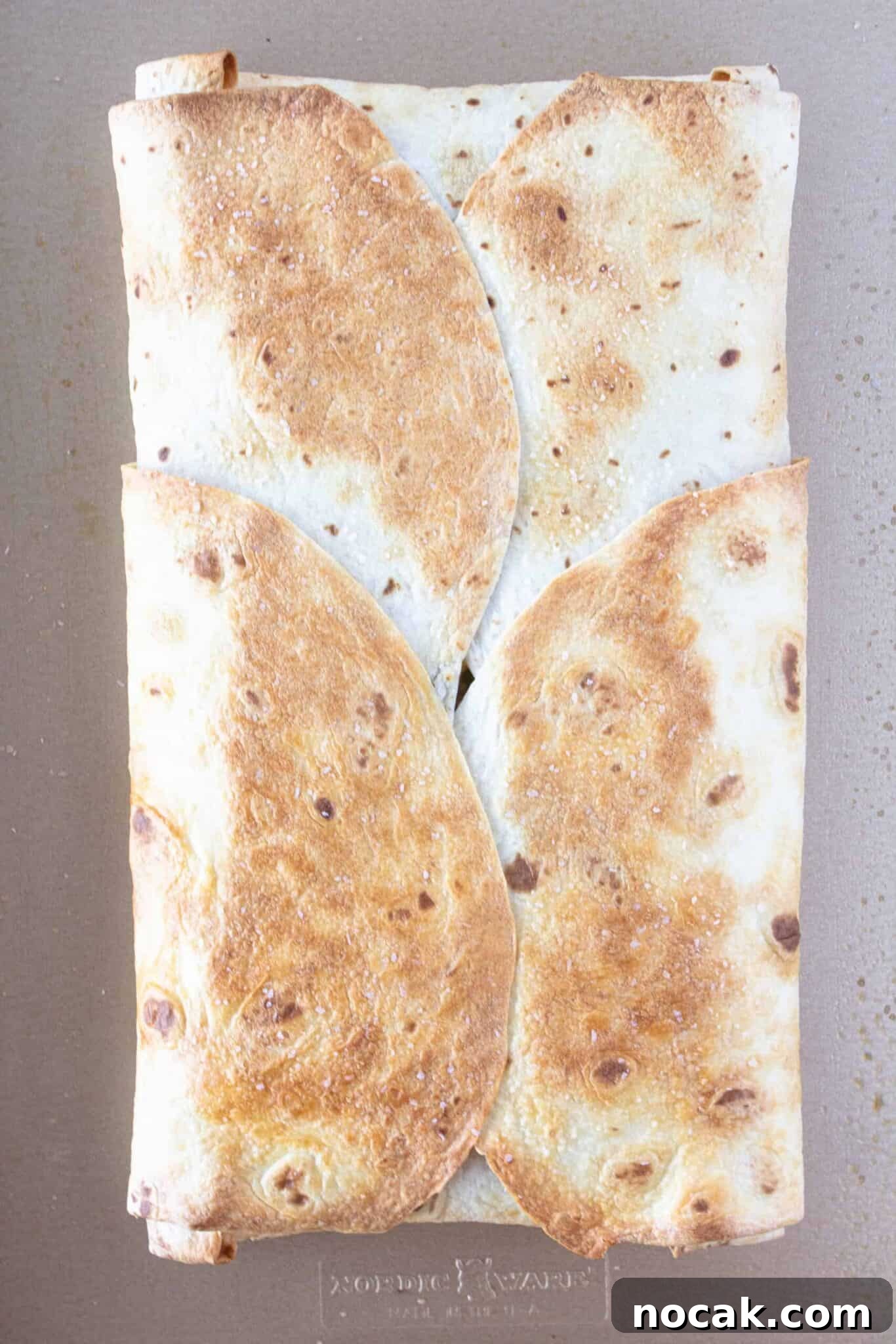 A baked Breakfast Quesadilla on a sheet pan.