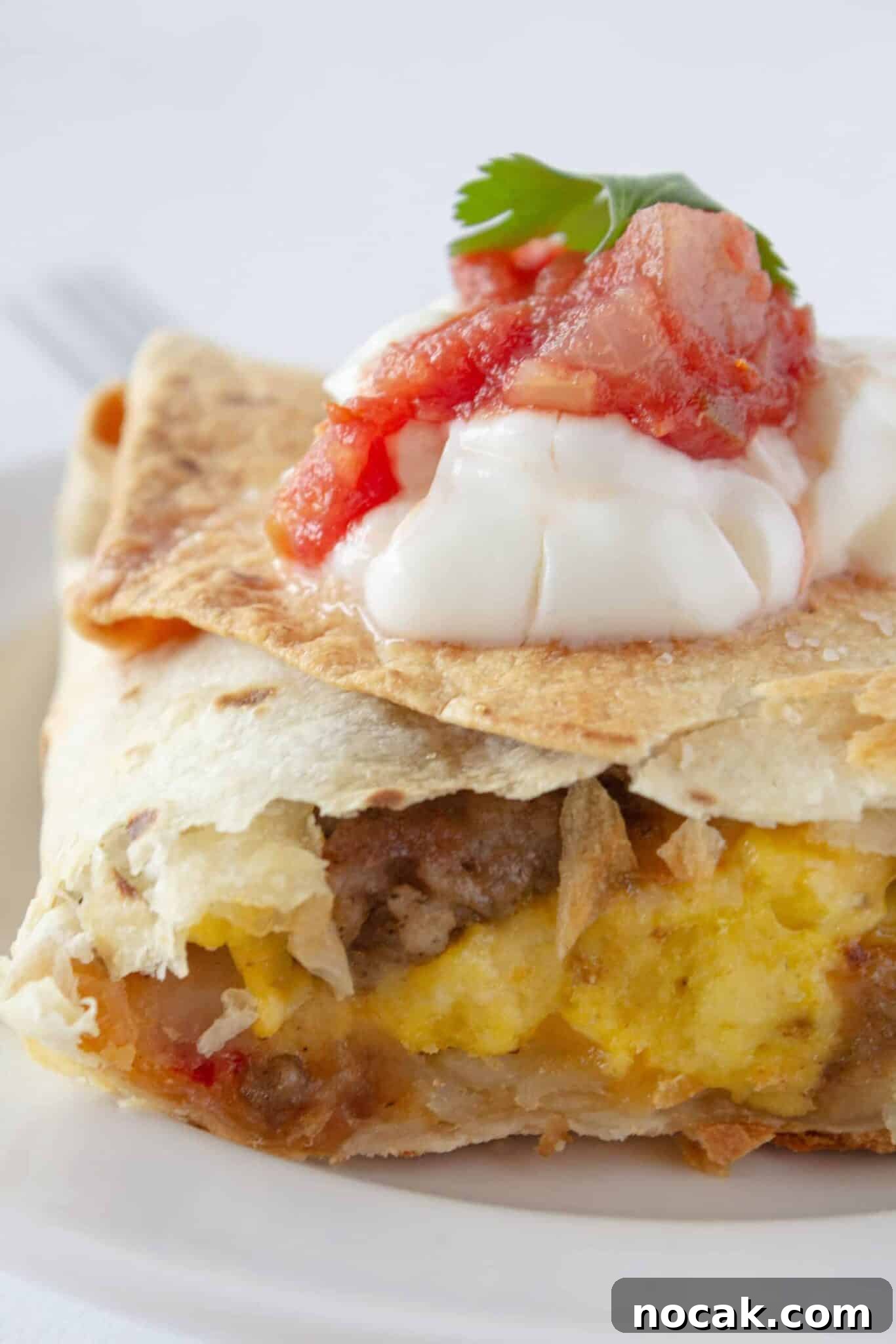 Sheet Pan Breakfast Quesadilla serving on a plate with toppings.