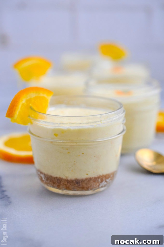 Single-serve jars of ginger cookie base and velvety, light-as-air Sous Vide Orange Mascarpone Cheesecake made with Tre Stelle Mascarpone.