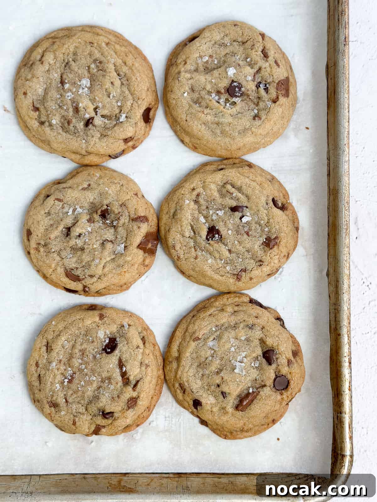 a close up of all 6 cookies on a baking sheet.