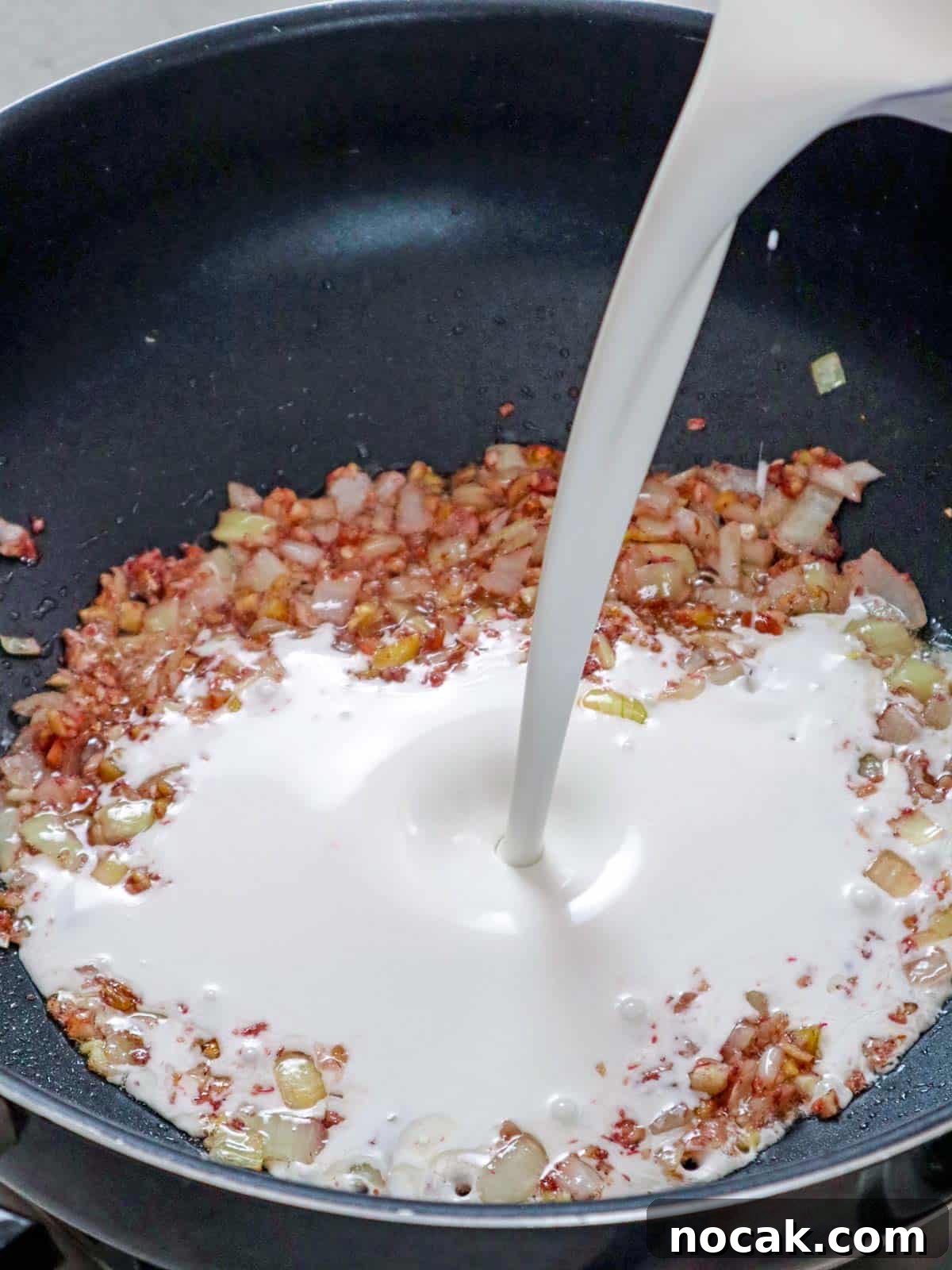 Seafood in Coconut Milk (Ginataang Seafood) Recipe 4 pouring coconut milk to sauteed onions, garlic, and sauteed shirmp paste