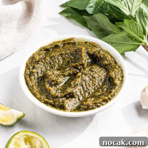Thai Basil Pesto in a bowl with ingredients to make it surrounding.