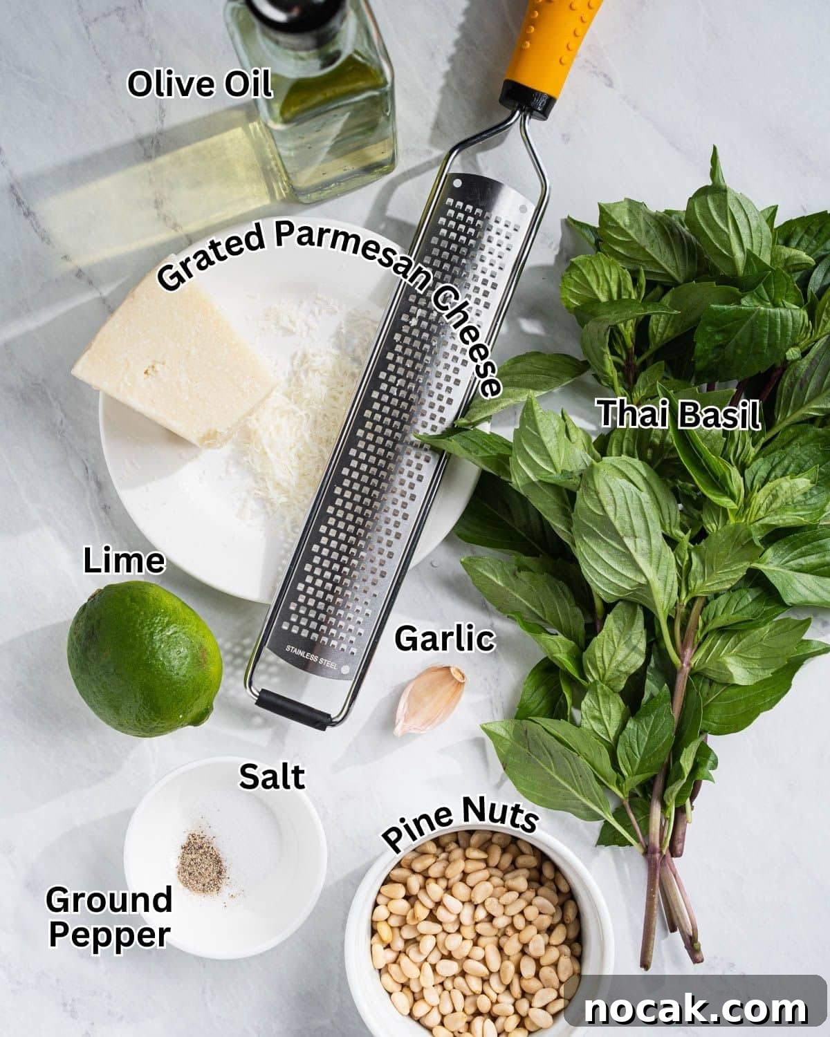 Ingredients needed to make Thai Basil Pesto: Thai Basil, Pine Nuts, lime, salt, pepper, garlic, grated Parmesan cheese, and olive oil.