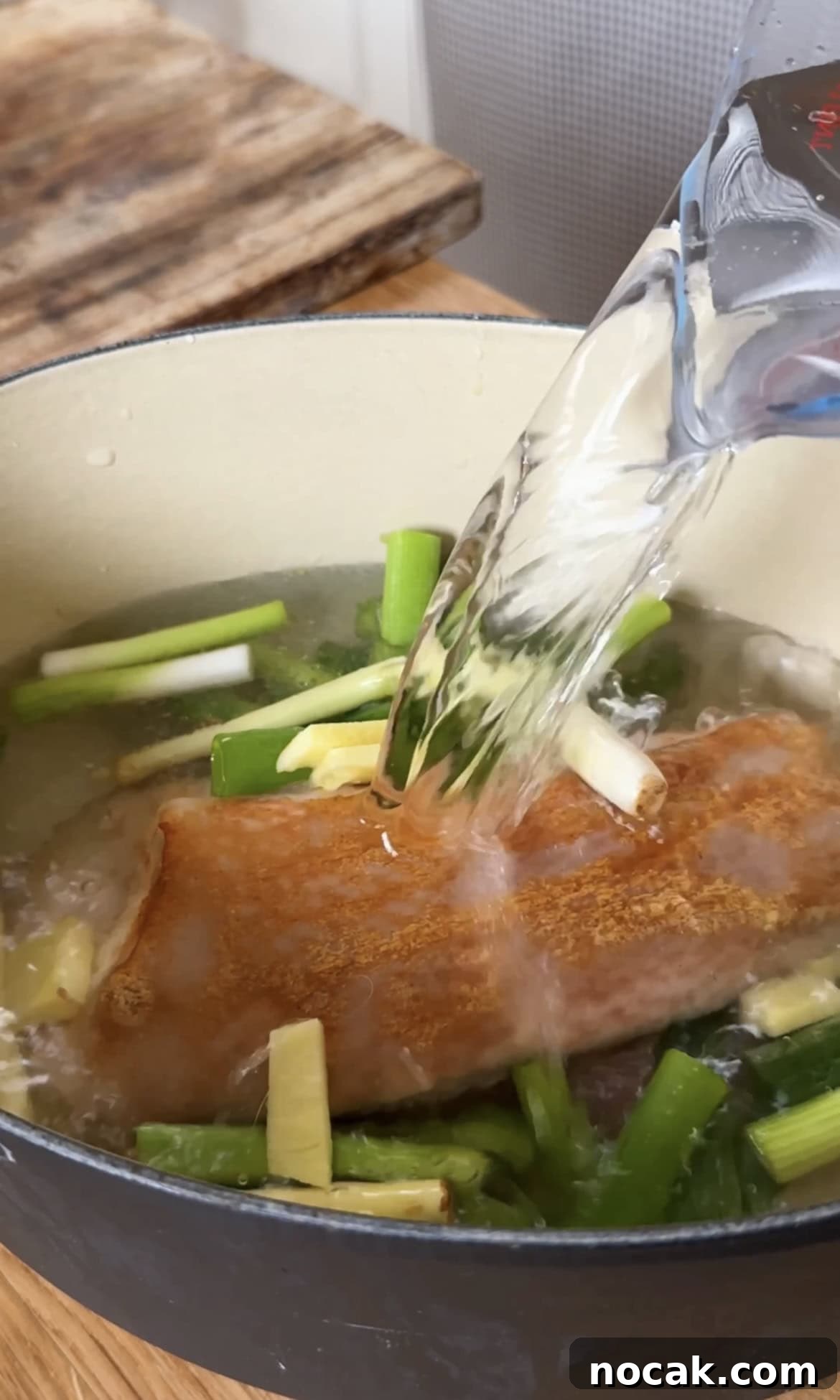 adding water to boil the pork belly.
