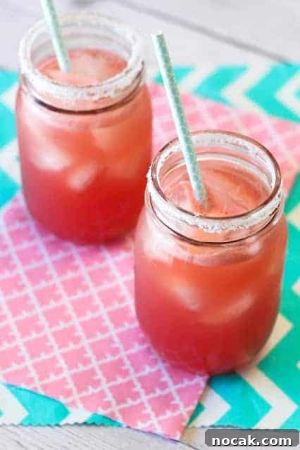 two fresh watermelon margarita cocktails in jars