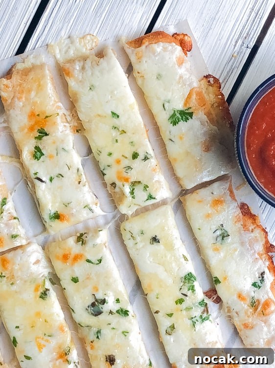 cheesy bread sticks with marinara sauce.