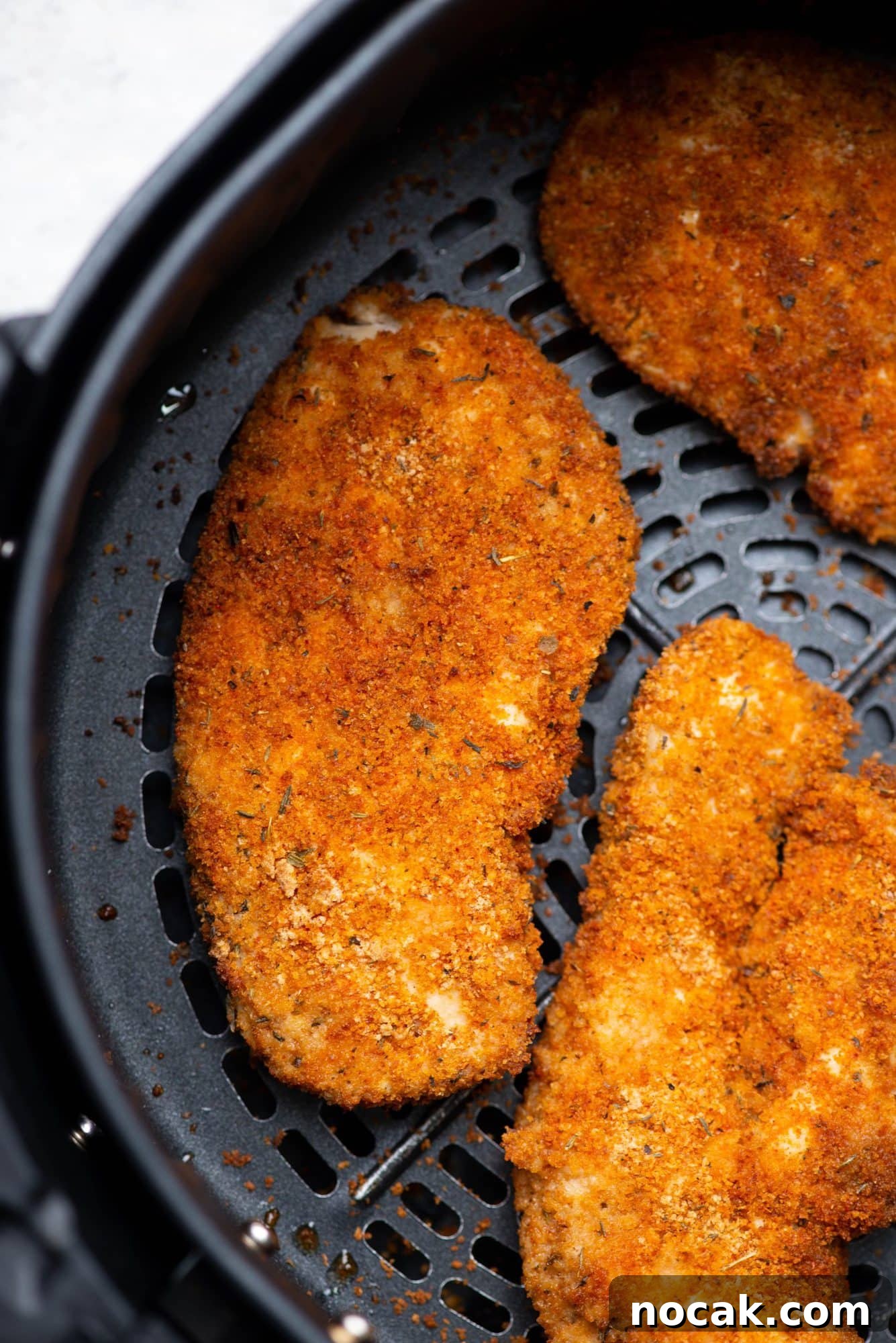 Crispy Air Fryer Chicken Breast 2 Crispy Crusty Chicken Breasts fried in an Air Fryer pan.