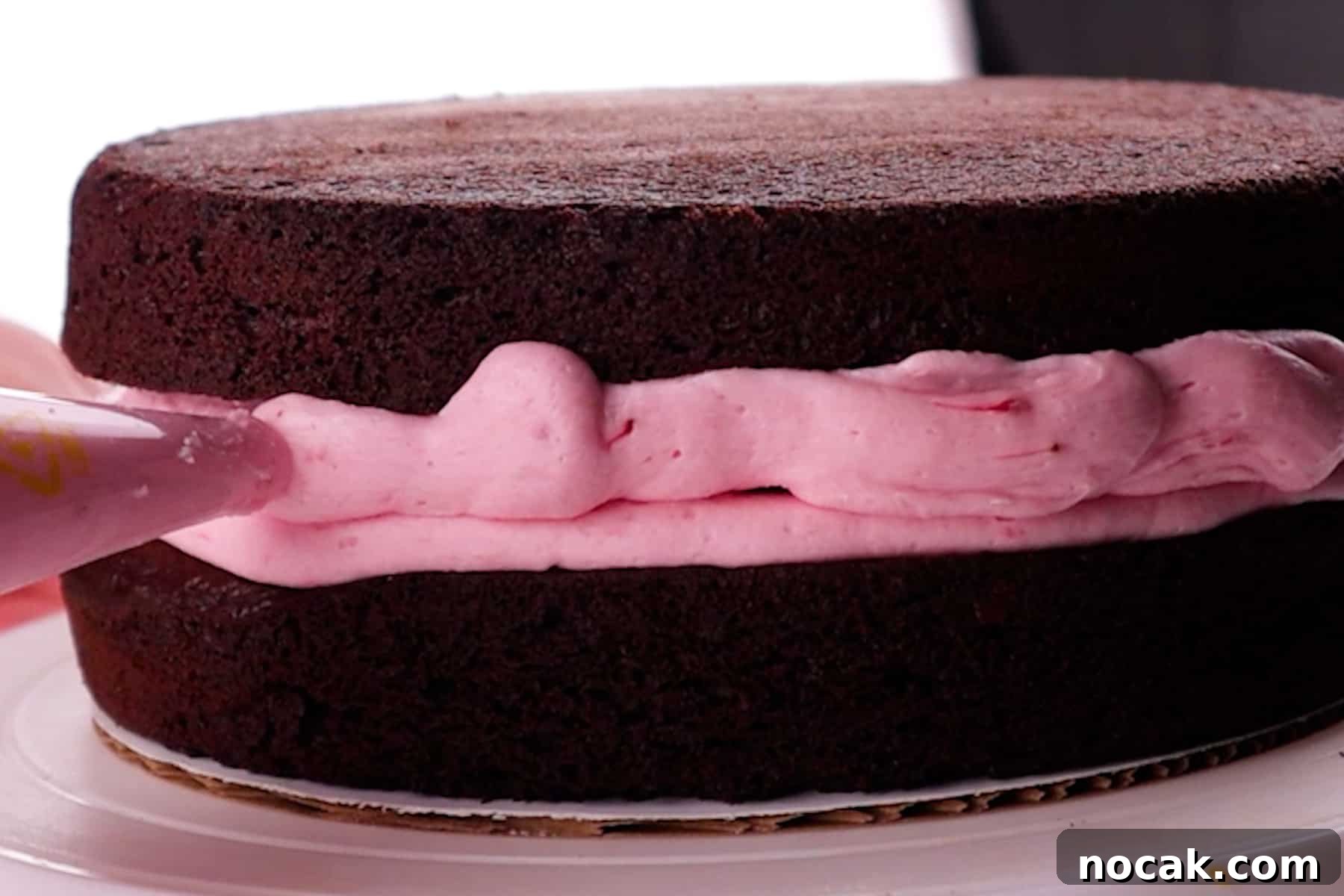 Chocolate Strawberry Layer Cake with Luscious Ganache 8 adding frosting to fill any gaps in between two layers of cake.