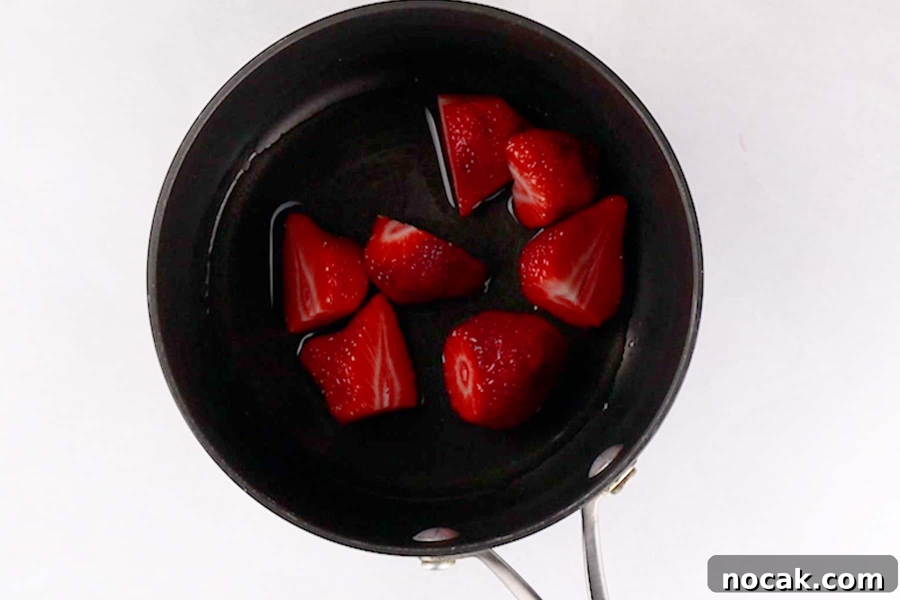 Chocolate Strawberry Layer Cake with Luscious Ganache 7 strawberries in sauce pan.