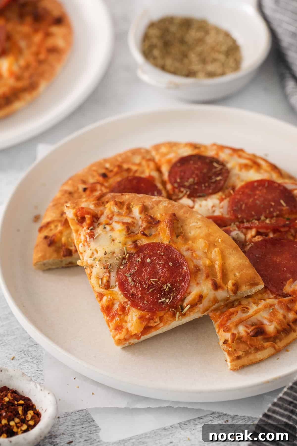 Air fryer frozen pizza Air fryer frozen pizza slices on a plate.