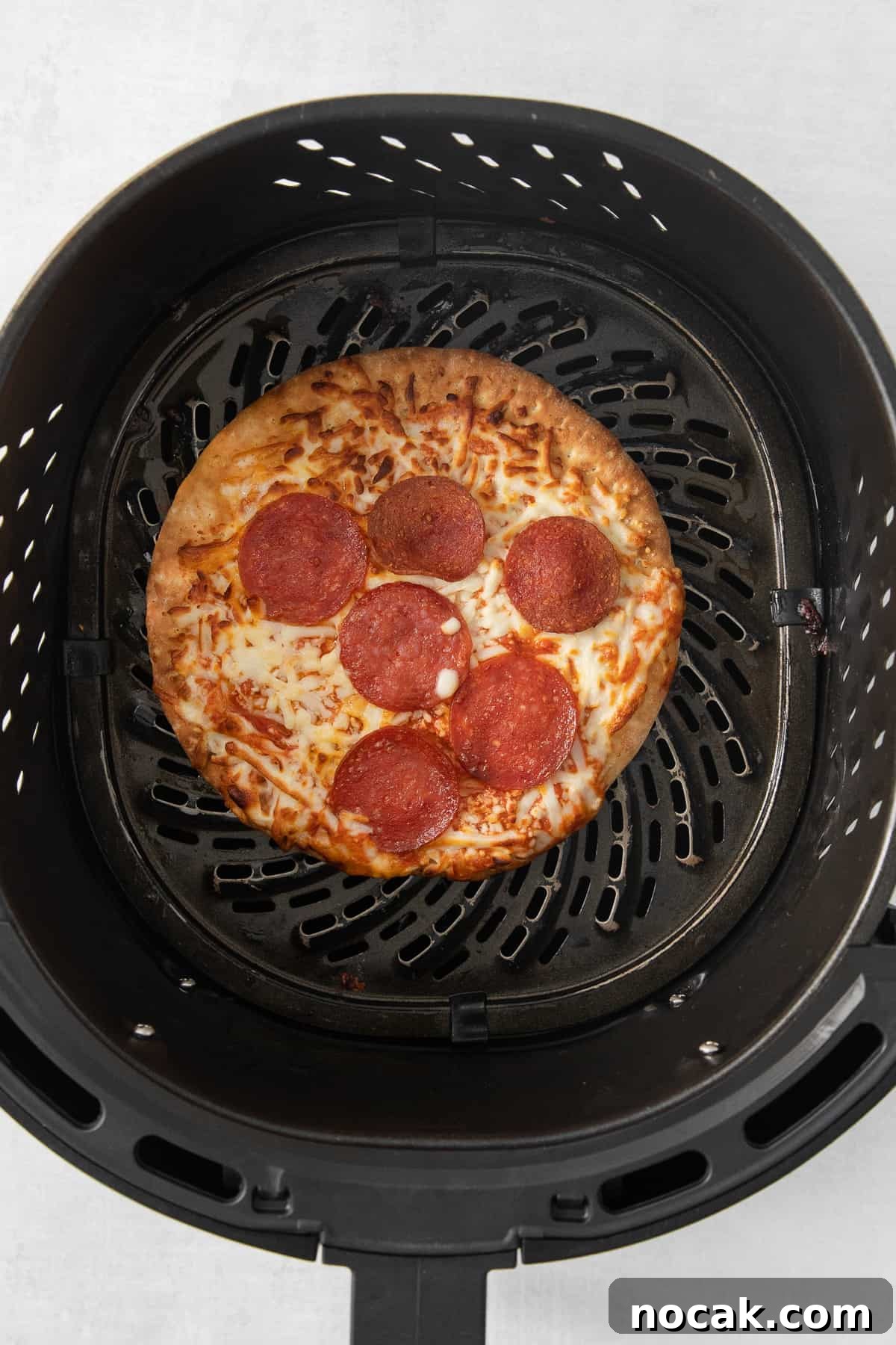 Pizza in air fryer Pizza cooking in the air fryer.
