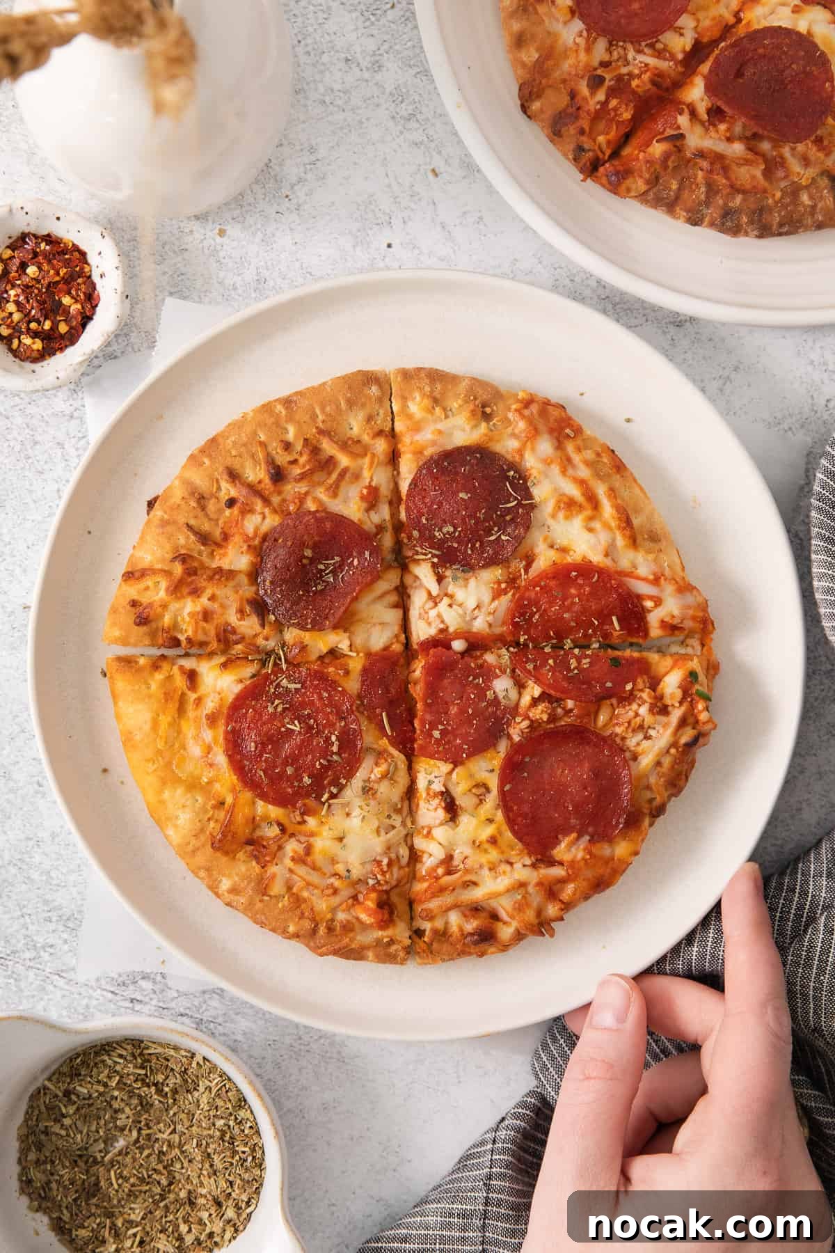 Sliced pizza on a plate Air fryer pizza on a plate cut into slices.