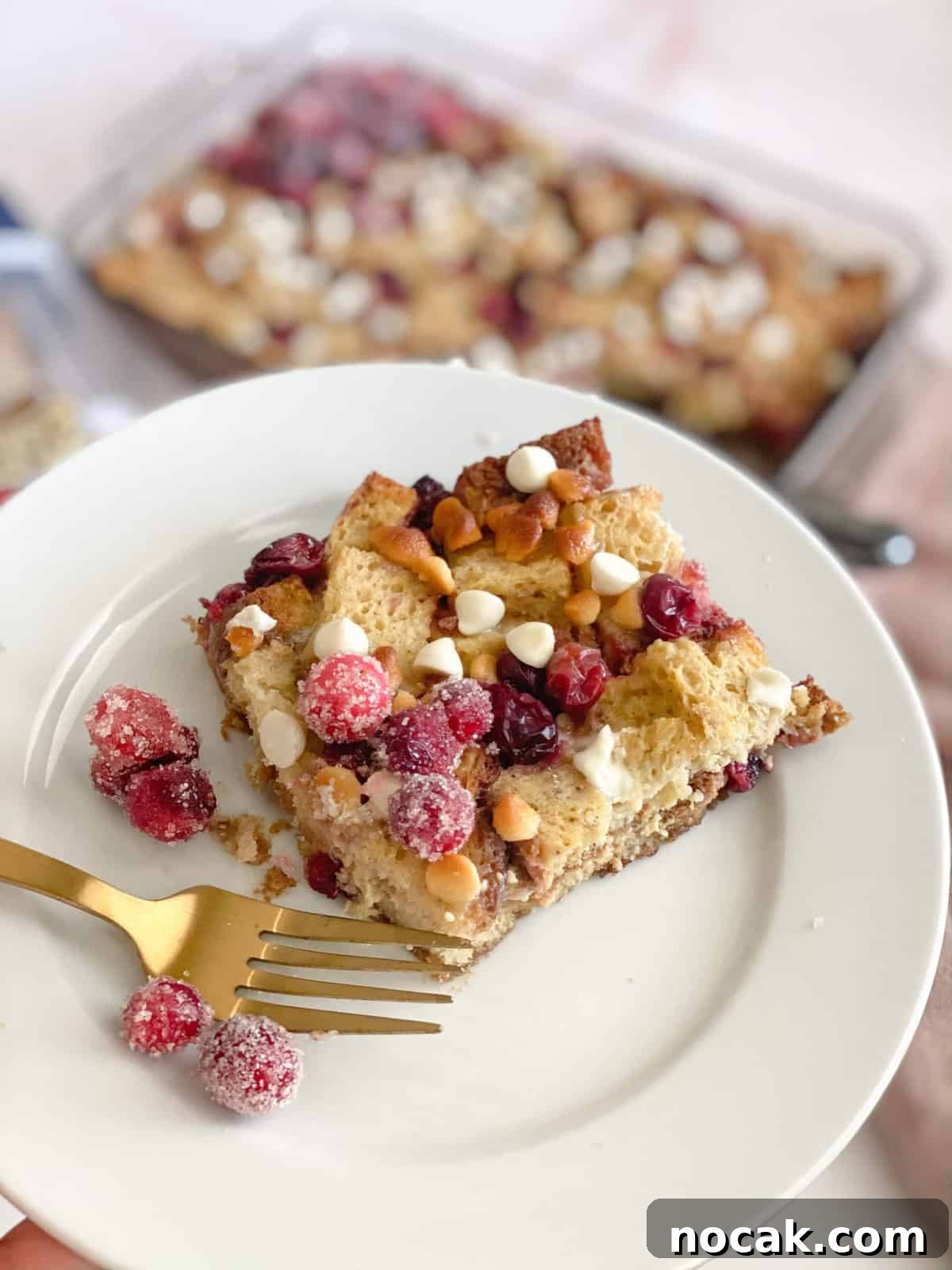 Gluten-Free French Toast Casserole with Cranberries & White Chocolate gluten-free French toast casserole in a square on a plate