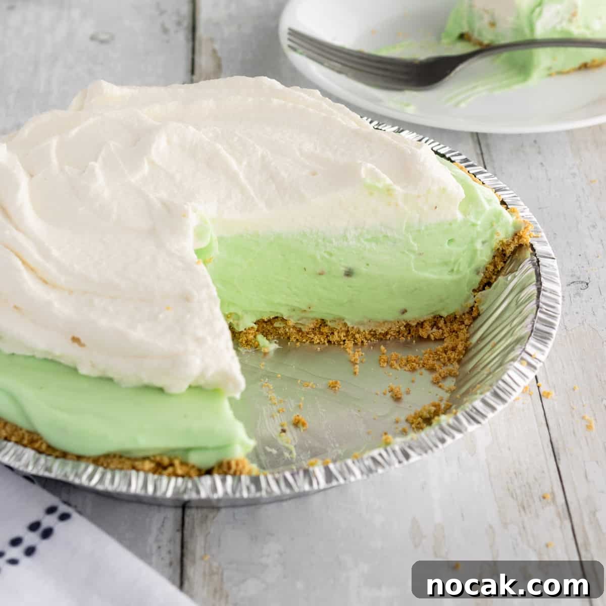 How to Meal Prep Your Thanksgiving Dinner 15 A pistachio pie with a piece taken out.