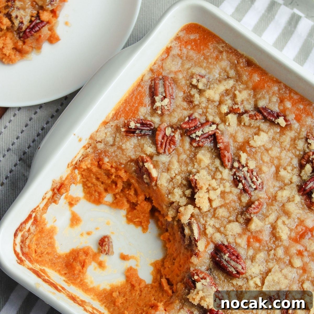 How to Meal Prep Your Thanksgiving Dinner 3 9x9 casserole dish with sweet potato casserole and a plate off to the side