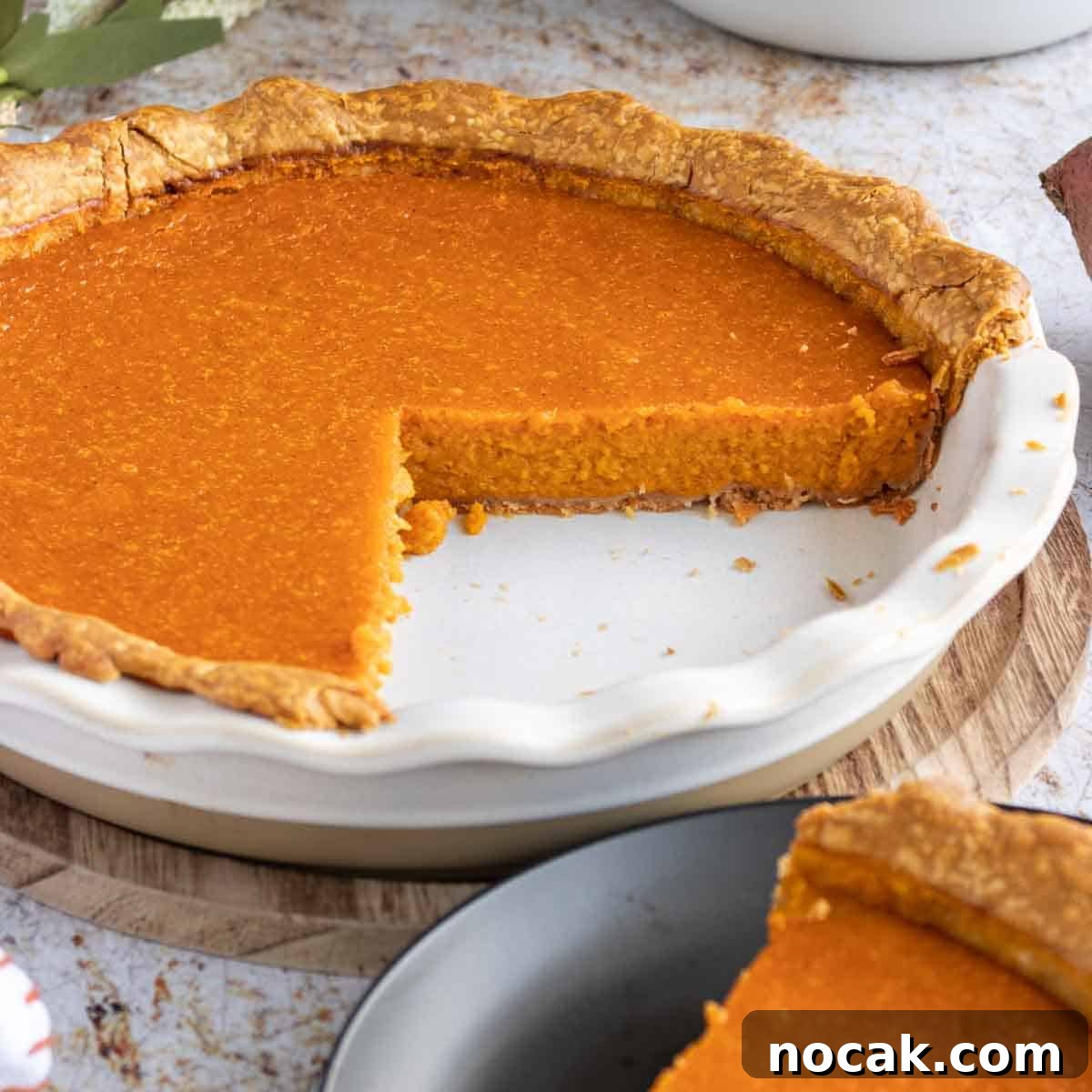 How to Meal Prep Your Thanksgiving Dinner 9 Cooked sweet potato pie with slice removed.